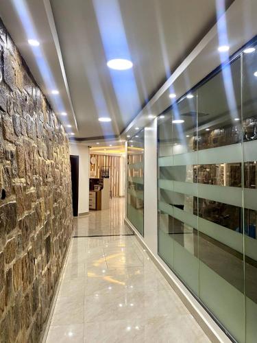 a hallway with glass shelves in a building at Cascadia Hotel Apartments by GF Greenland in Kigali