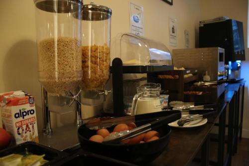 a counter with a table with a bowl of eggs at Safestay Edinburgh Cowgate in Edinburgh