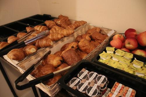 a group of baskets filled with different types of pastries and apples at Safestay Edinburgh Cowgate in Edinburgh