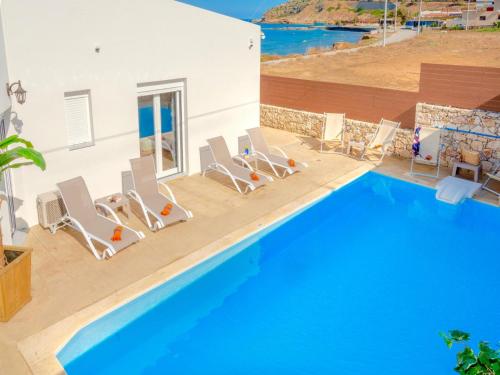 a group of chairs and a swimming pool at Villa Sky in Skaleta