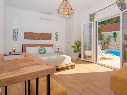 a bedroom with a bed and a desk and a patio at Villa Sky in Skaleta