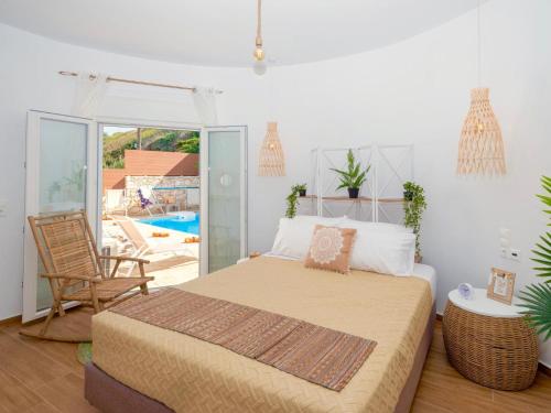 a bedroom with a bed and a patio with a pool at Villa Sky in Skaleta