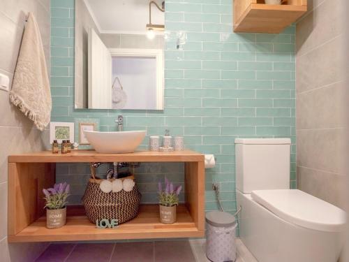 a bathroom with a sink and a toilet at Villa Sky in Skaleta