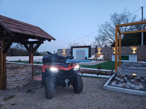 a dirt bike parked in front of a house at Vikend house Cvrcak in Slankamenački Vinogradi