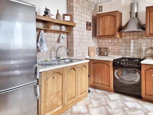 a kitchen with a stainless steel refrigerator and a sink at Izabelin Apartment in Swarzędz