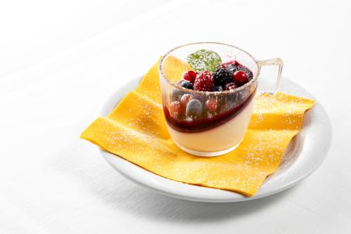 a plate of food with a drink on top at Albergo La Rocca in Brisighella