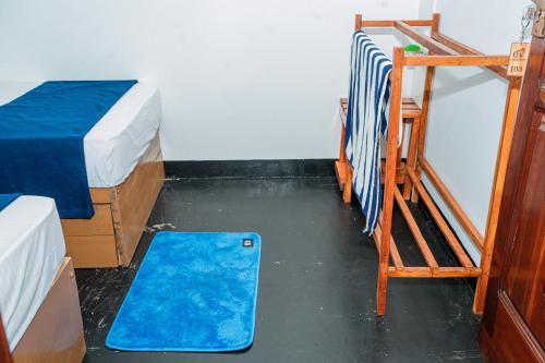 a room with two bunk beds and a blue rug at Coastal Heaven Villa in Trincomalee