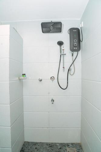 a bathroom with a shower with a phone on the wall at Coastal Heaven Villa in Trincomalee