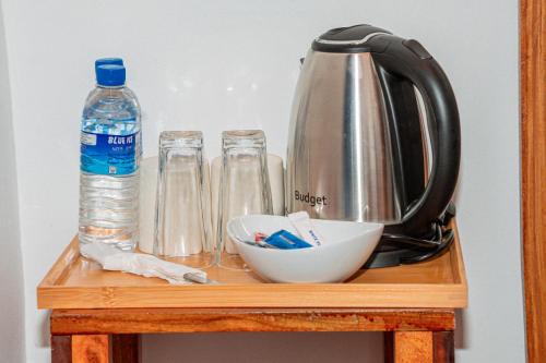 a table with a tea kettle and two bottles of water at Coastal Heaven Villa in Trincomalee