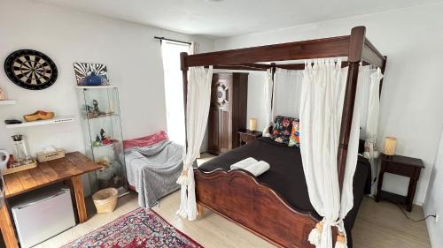 a bedroom with a bed with a canopy at Two nice rooms in residential area with private bathroom in Almere