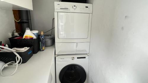 a white washer and dryer in a kitchen at Two nice rooms in residential area with private bathroom in Almere