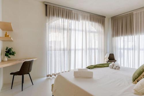 a white bedroom with a large window and a bed at Italian Experience- Suite Marè in Porto Recanati