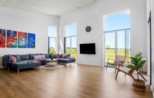 a living room with a couch and a tv at Beautiful Home In Børkop With Sauna in Børkop