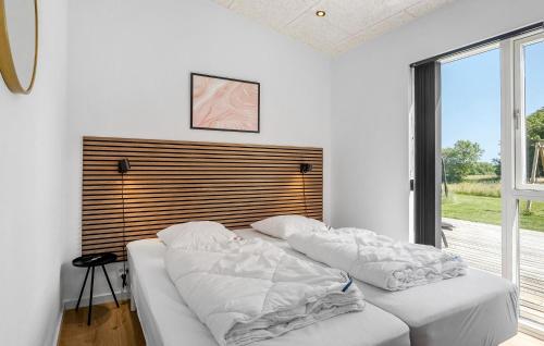 a bedroom with two white pillows on a bed at Beautiful Home In Børkop With Sauna in Børkop