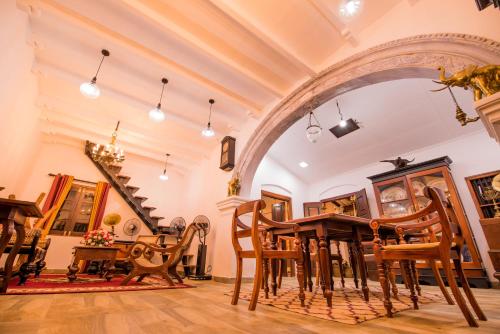a dining room with a table and chairs at Fortress de Jayaweera - Historic Villa Bentota - A proud legacy since 1889 in Bentota