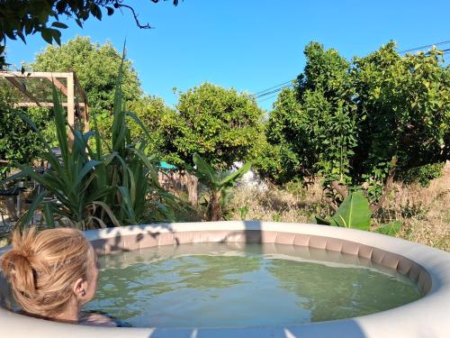 a woman is sitting in a pool of water at Casa Terapia in Loulé