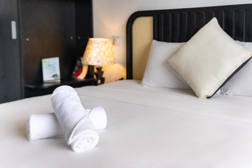 a pile of rolled up towels on a bed at Moc Lam Homestay GrandWorld Phu Quoc in Phu Quoc