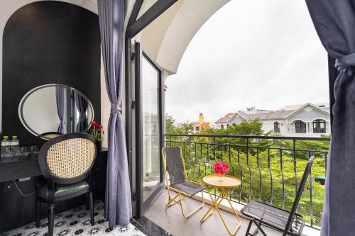 a balcony with chairs and a table with a view at Moc Lam Homestay GrandWorld Phu Quoc in Phu Quoc