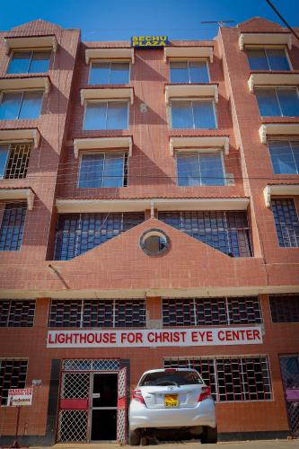 a building with a car parked in front of it at Khalisee homes studio apartment 3 in Voi