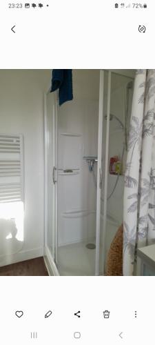 a bathroom with a shower with a glass door at Les roses à la plage in Veules-les-Roses