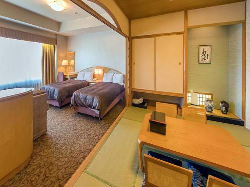 a hotel room with two beds and a desk at LiVEMAX RESORT Hakodate Greenpia Onuma in Mori