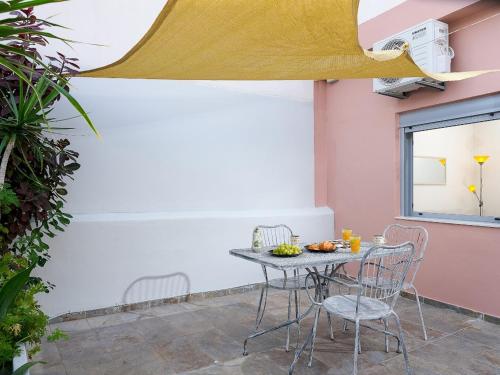 a table and chairs sitting on a patio at The Museum View Suite in Heraklio Town