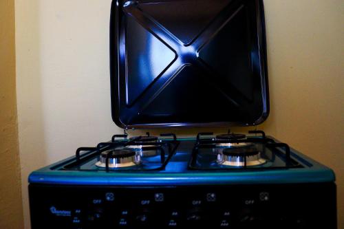 a microwave sitting on top of a stove at Khalisee homes studio apartment 3 in Voi
