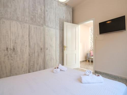 a bedroom with a white bed with towels on it at The Museum View Suite in Heraklio Town