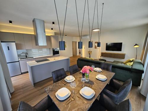 a kitchen and living room with a table and chairs at Vila Aurora in Vrsar