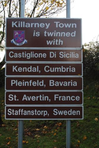 a street sign with several signs on it at Abbey Lodge in Killarney