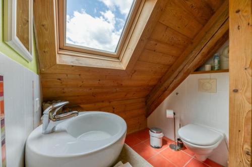 a bathroom with a white sink and a window at Auberge Passoud 203 in Vaujany
