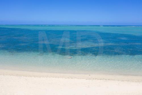 a beach with a person in the water at Villa Philibert in Riambel
