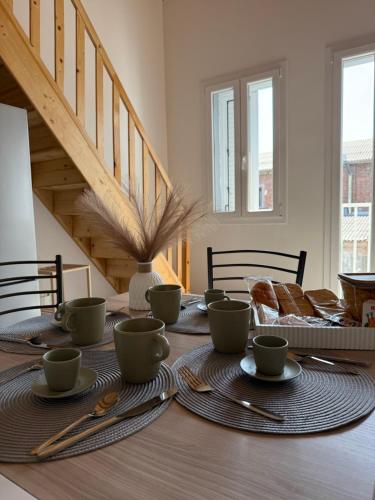 a dining room table with plates and utensils on it at Francesco's house-airport in Bologna