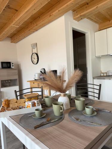 a kitchen with a table with cups and plates on it at Francesco's house-airport in Bologna