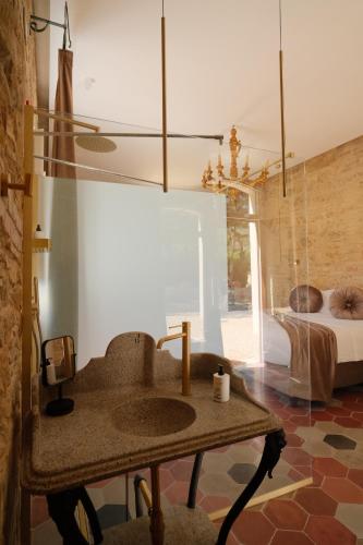 a bathroom with a sink and a bedroom with a bed at Leano Agriresort in Piazza Armerina