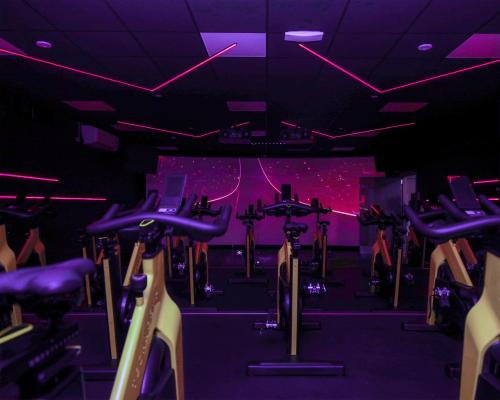 a gym with rows of exercise bikes in a room at Village Hotel Bracknell in Bracknell