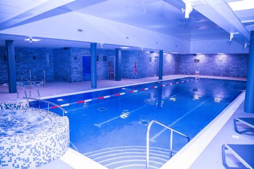 a large swimming pool in a building at Village Hotel Bracknell in Bracknell