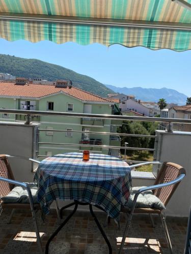 a table and chairs on a balcony with a view at Budva in Budva