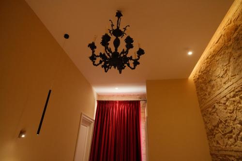 a chandelier in a room with a red curtain at Leano Agriresort in Piazza Armerina