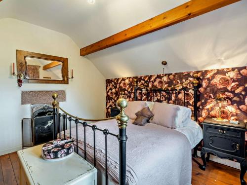 a bedroom with a bed and a wall covered in flowers at 1 Bed in Barrow-in-Furness 91590 in Barrow in Furness