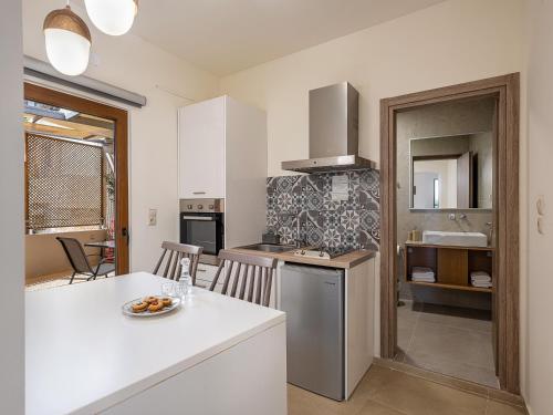 a kitchen with a white counter top and a table at Casa D'Irene Deluxe Hotel in Falasarna