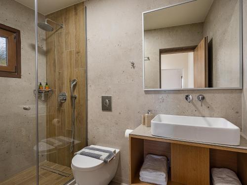 a bathroom with a sink and a toilet and a shower at Casa D'Irene Deluxe Hotel in Falasarna