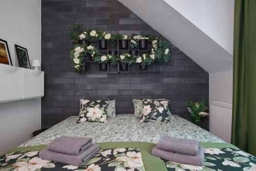 a bedroom with a bed with two pillows on it at Apartamenty Śniadanie do Łóżka in Pobierowo