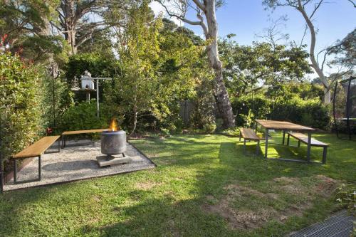 a backyard with two picnic tables and a grill at Blackheath Suite (2 b/rooms) Family/Pet Friendly in Blackheath