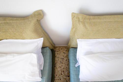 a bedroom with two beds with pillows at Family House in Lakones in Paleokastritsa