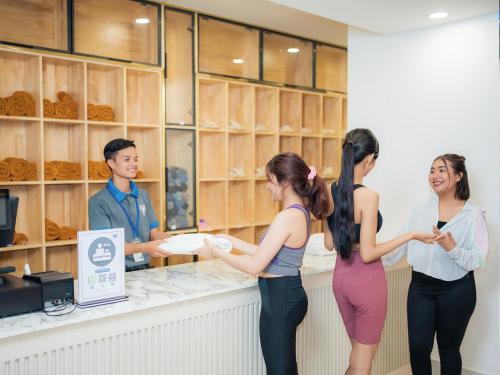 a group of people standing around a counter in a bakery at TV-Tower 1 in Phnom Penh