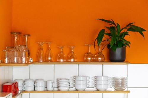 a shelf with cups and vases and a plant at Schanzenstern Altona GmbH in Hamburg