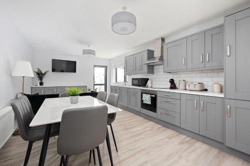 a kitchen with a table and chairs in a room at North Dublin Homestay in Dublin