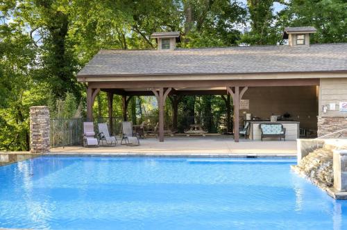 a pavilion with a swimming pool in a backyard at New Lakeside Haven - Picturesque in Branson