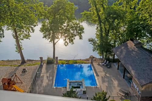an overhead view of a swimming pool next to a lake at New Lakeside Haven - Picturesque in Branson